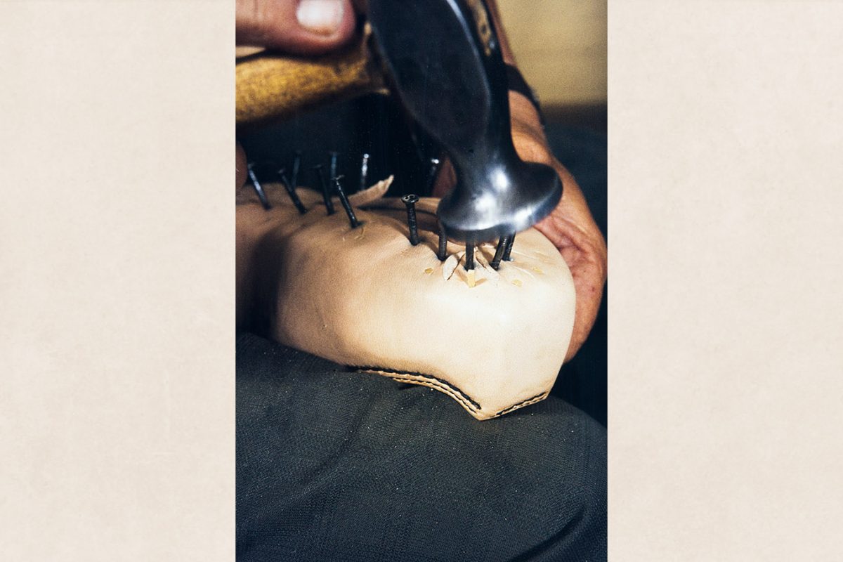 61_2282_134_valmis After drying the leather on the sides of the shoe, attach the sides of the shoe (edge) to the last with wooden nails, 1982. Photo: Kari Jämsén / KUHMU